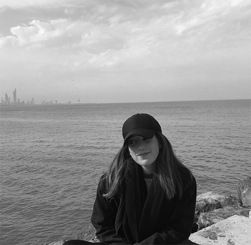 Image of Yoland with the sea behind her